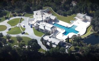 Helicopter view of a house with pool